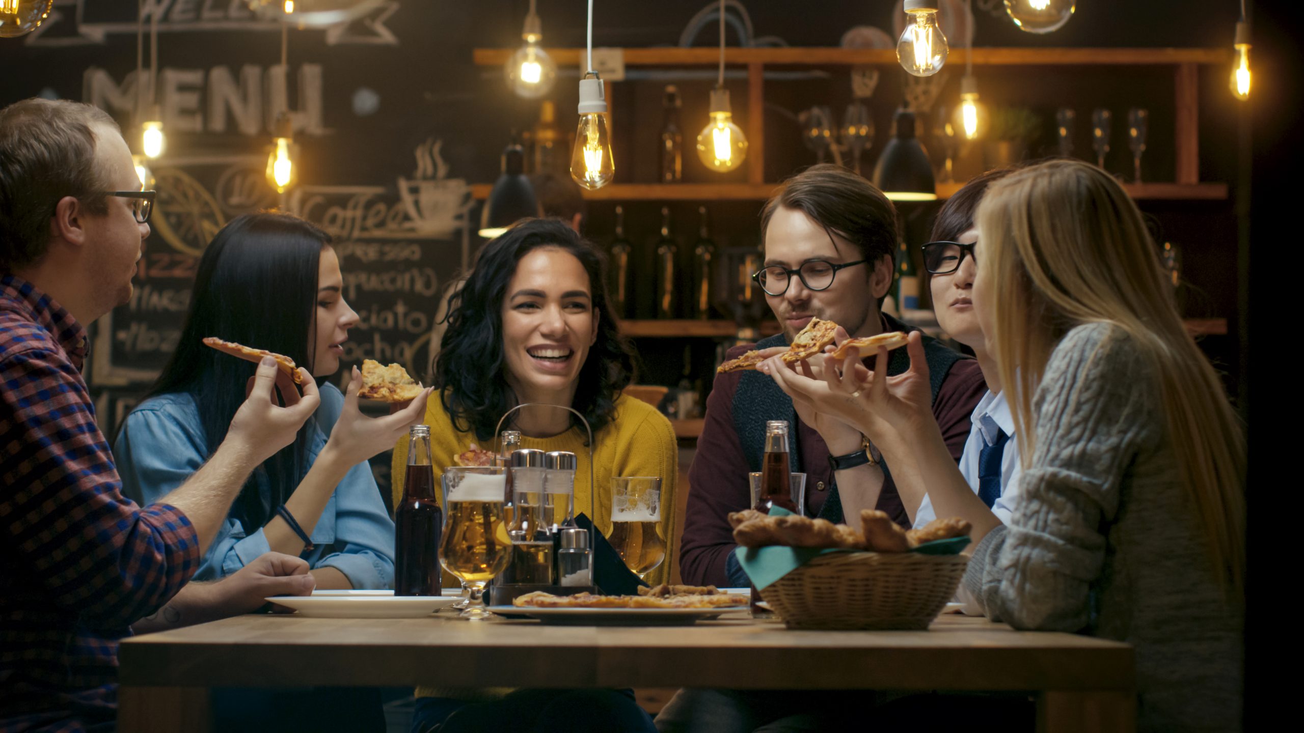 Friends sharing pizza at a restaurant